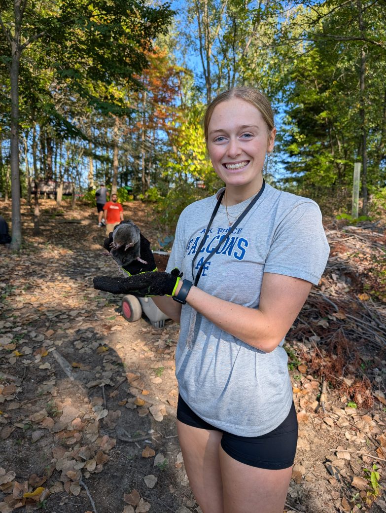 A girl happy with a bird at the hand