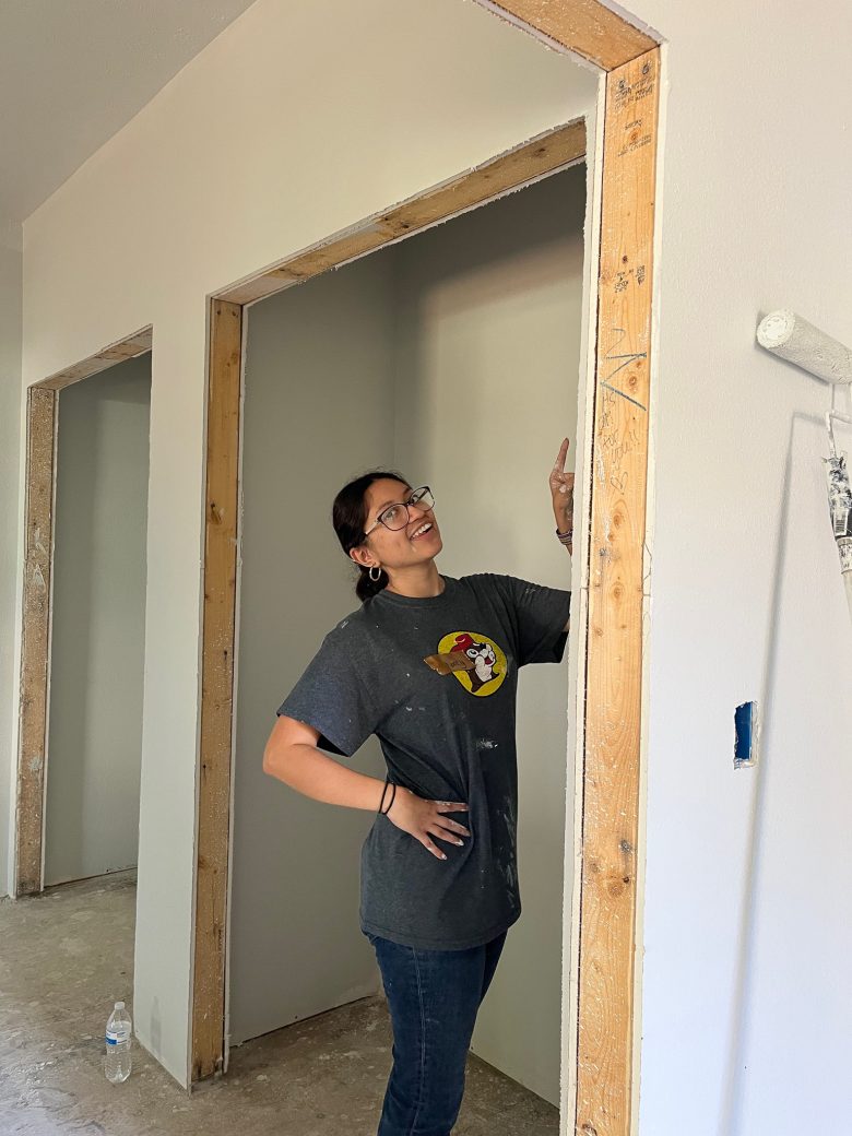 a woman taking measurements of the door