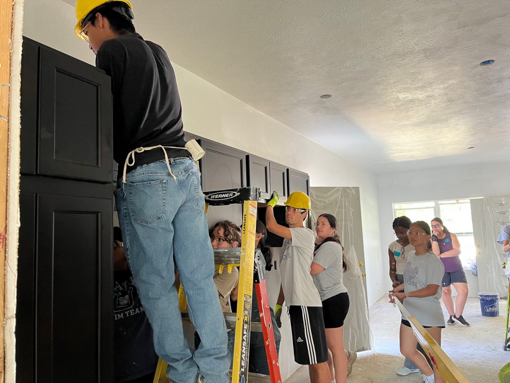 Mens taking the measurements of the house