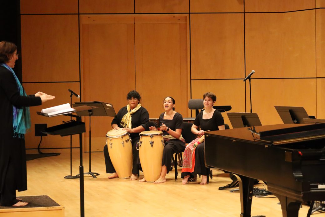 Students play hand drums at Homecoming Music Gala