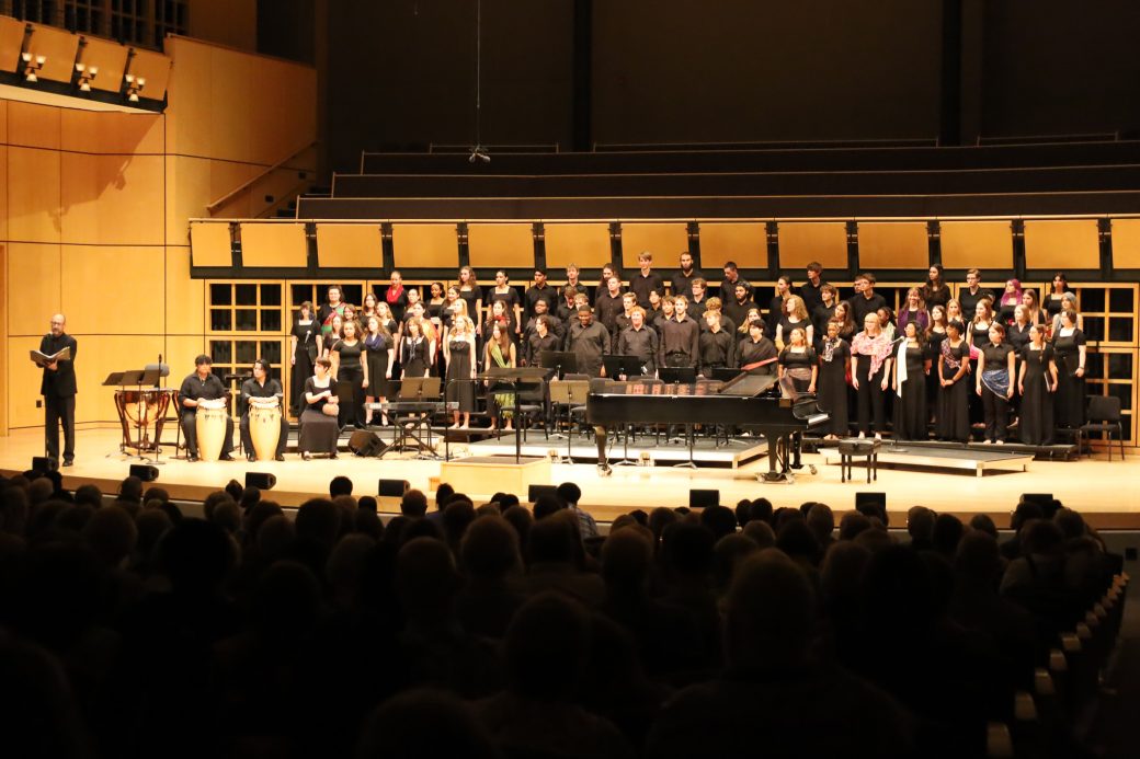Wide group shot of student performing on stage