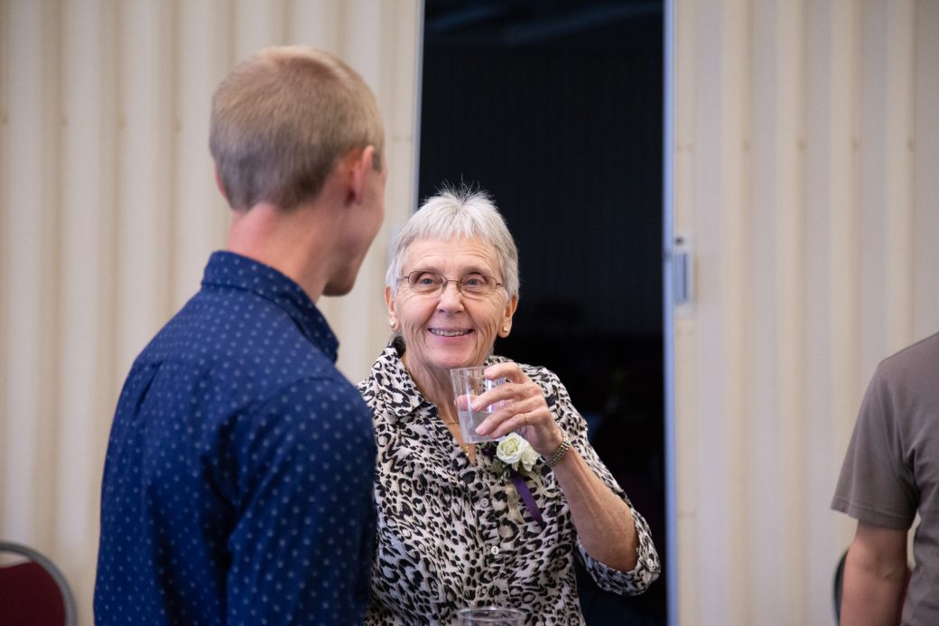 A man and a women talking at 2025 Alumni Awards Convocation