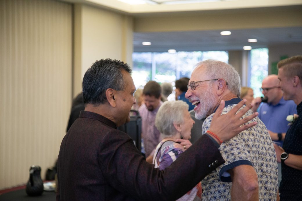 Two men hugging at 2025 Alumni Awards Convocation