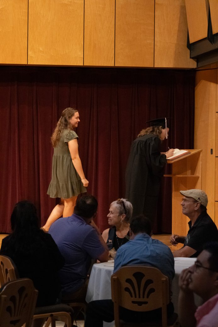 Public looking at two woman at stage in celebration day 2025