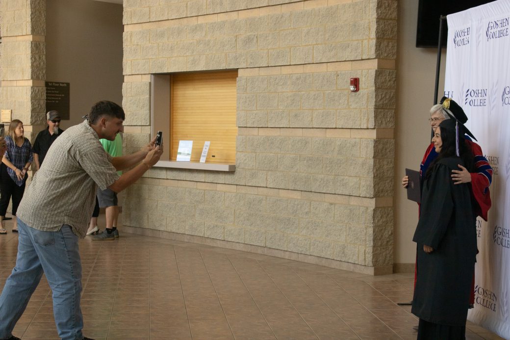 Man taking a photo of two woman