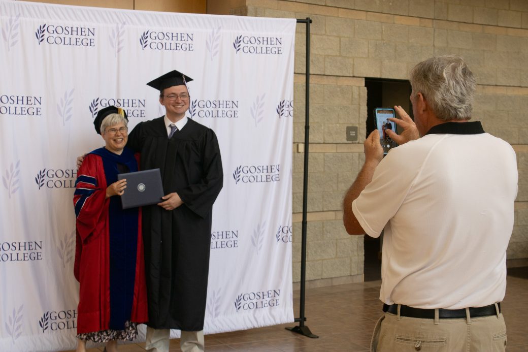 A man taking a photo of a man and a women
