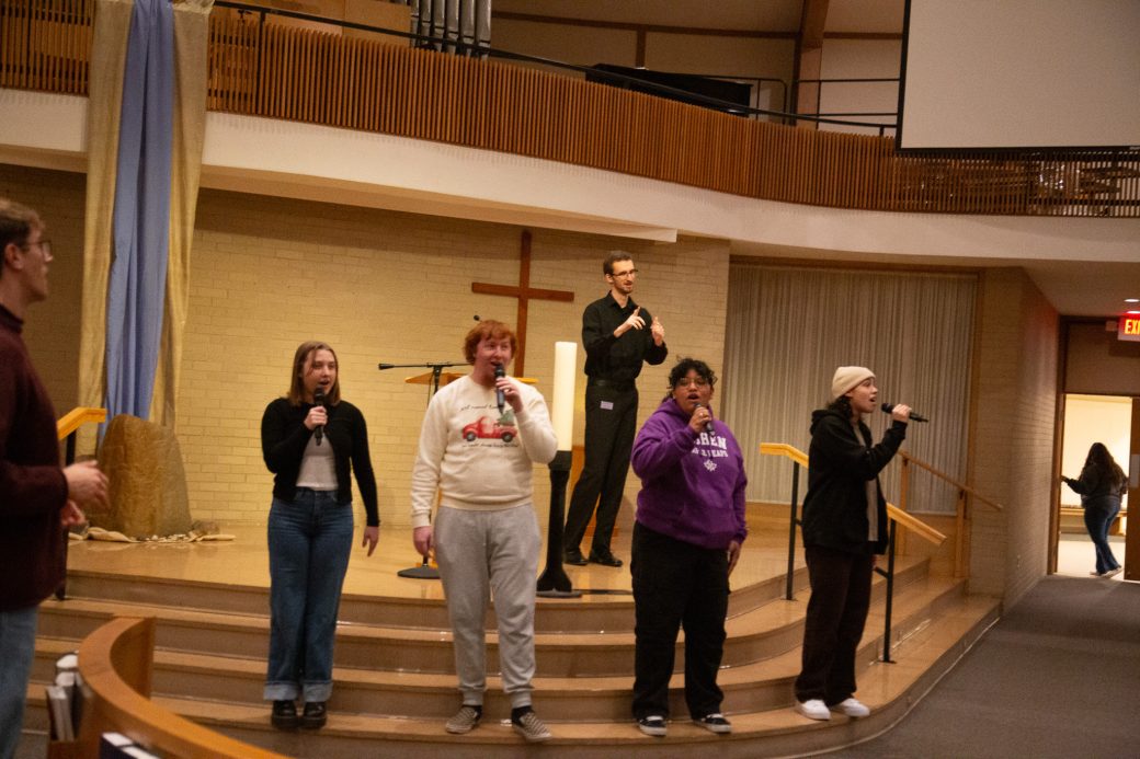 Students sing on stage in the Church-Chapel as part of the celebration.