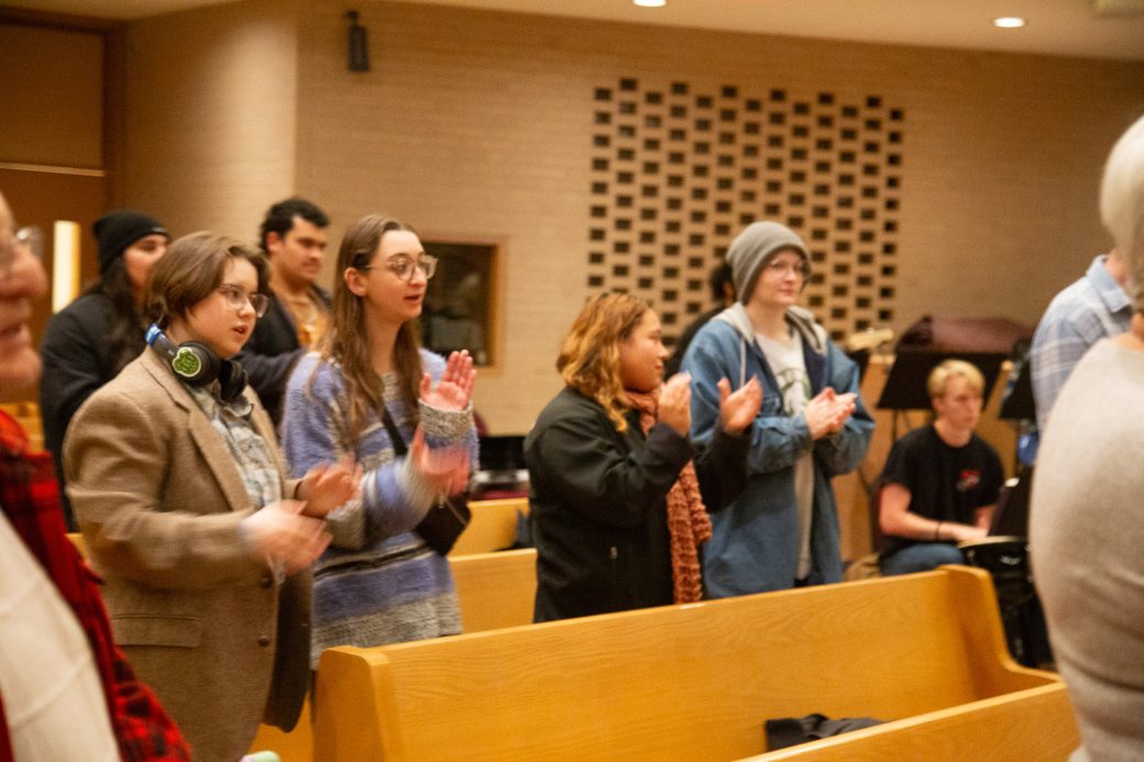 Students, faculty and community members join together in prayer as part of the Advent ceremony