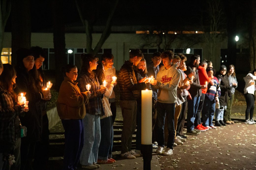 Audience help spread light by sharing their candle flames with others.