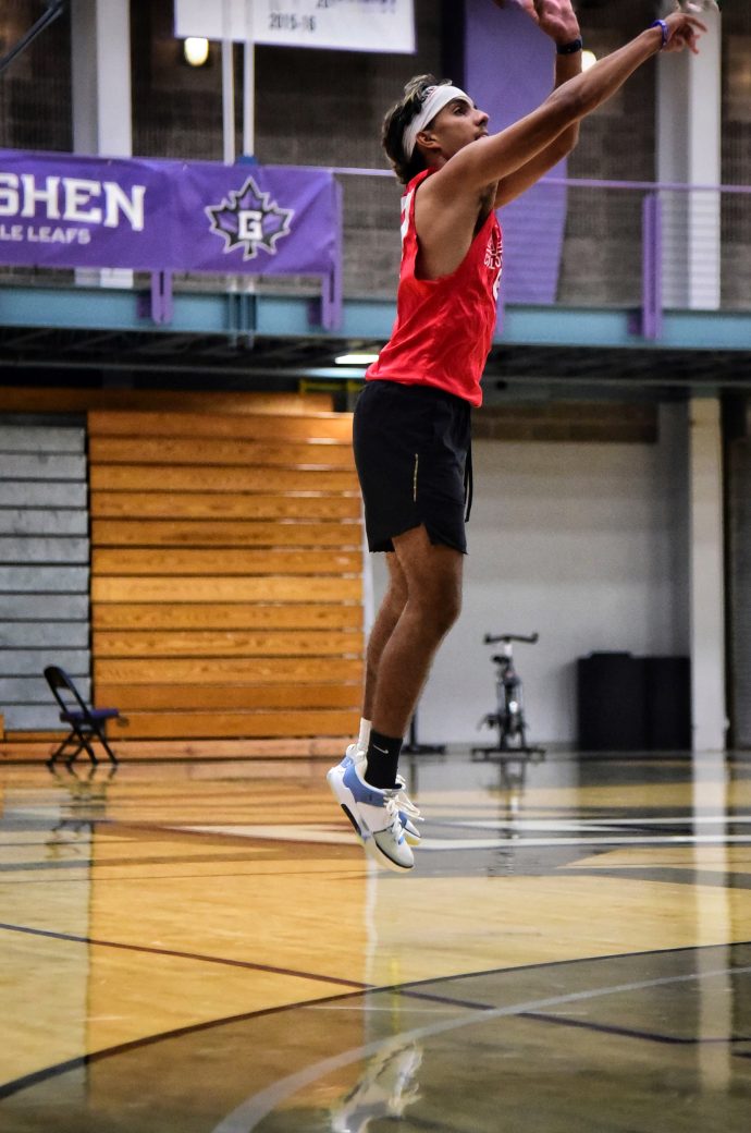 Male player in red tanktop makes jump shot