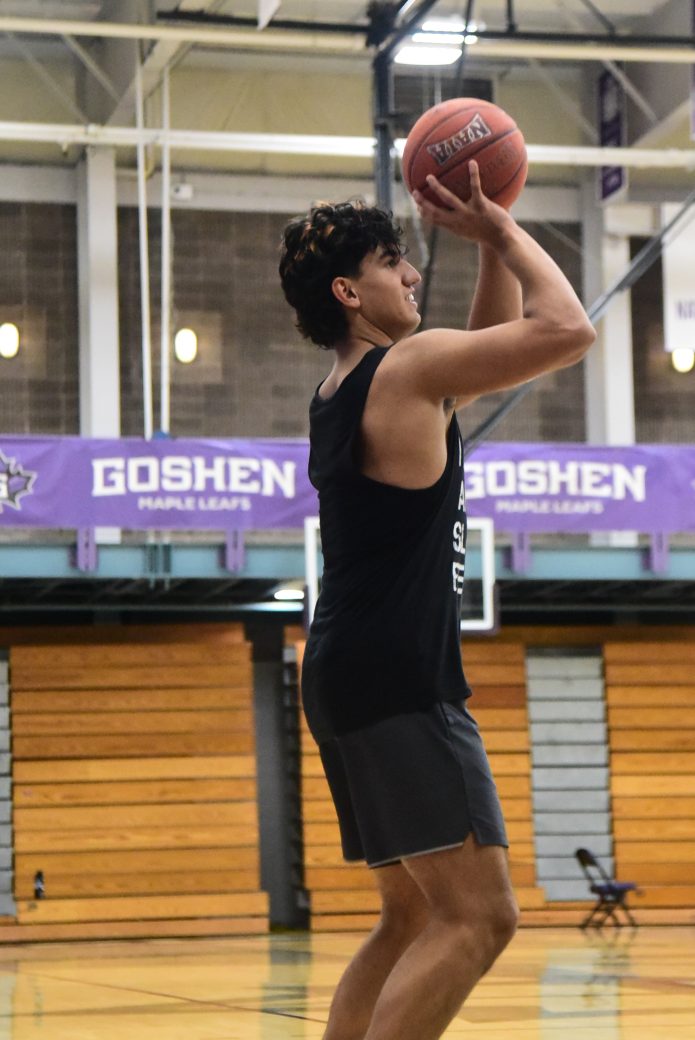 Male player in black tanktop prepares to make a shot.
