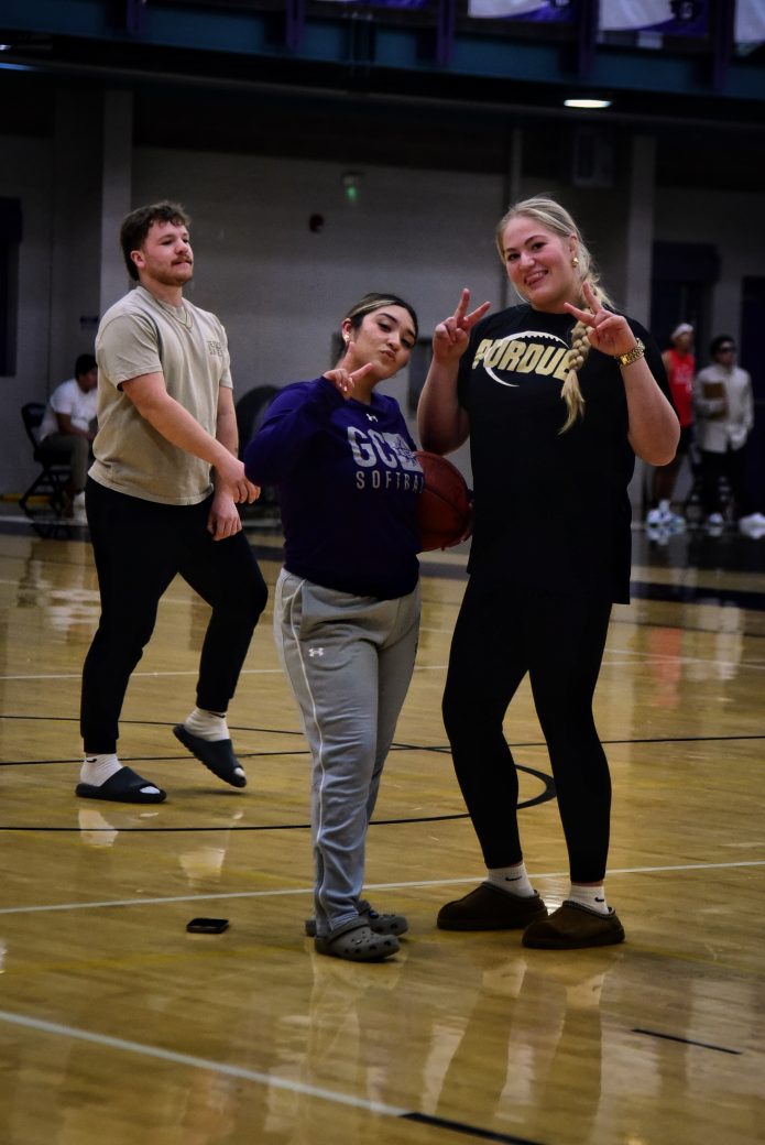Two female team members pose for the camera