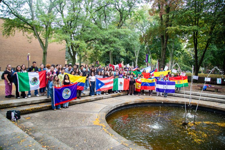 Students holding flags from Hispanic countries in honor of Hispanic Heritage Month