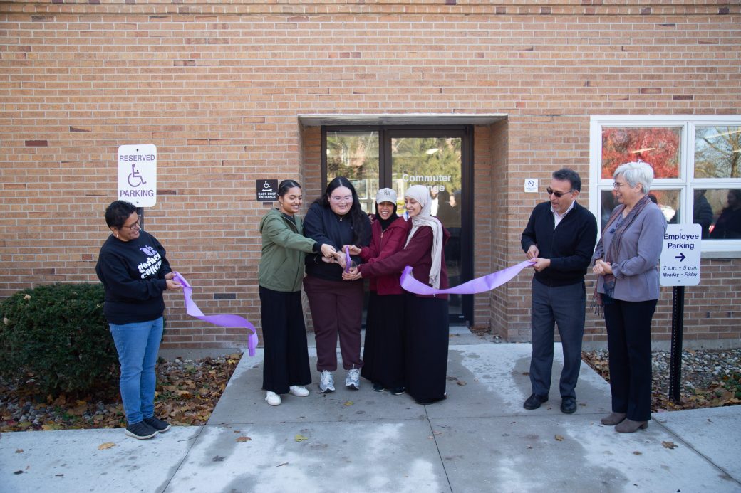 Students cut the ribbon at the grand opening of the Commuter Lounge.