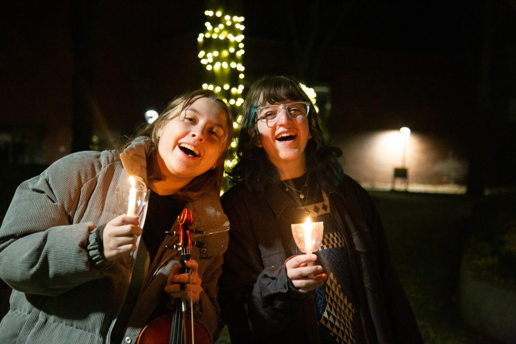 Students hold candles at the Campus Lighting.