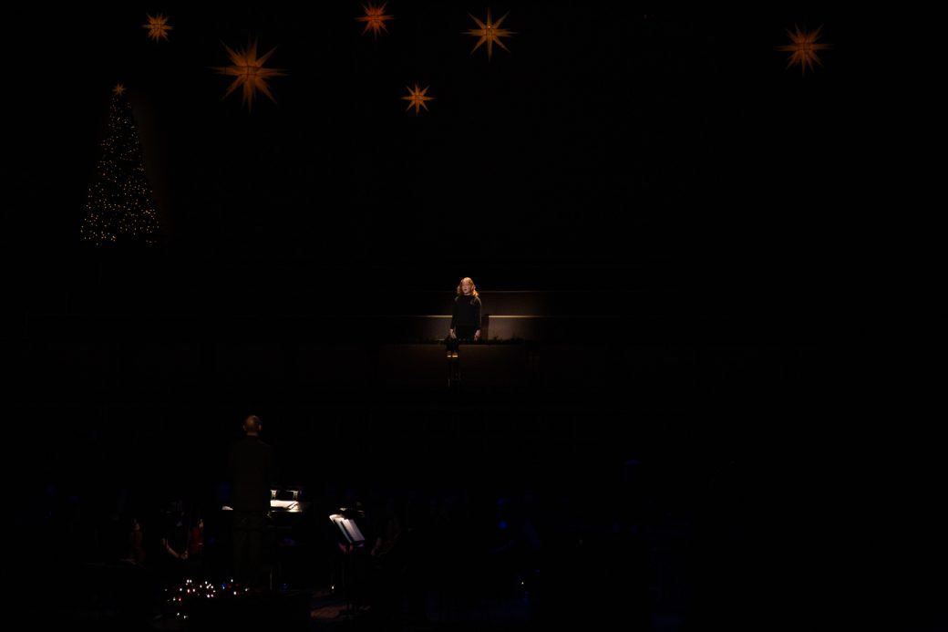 Singer stands alone in a sea of darkness