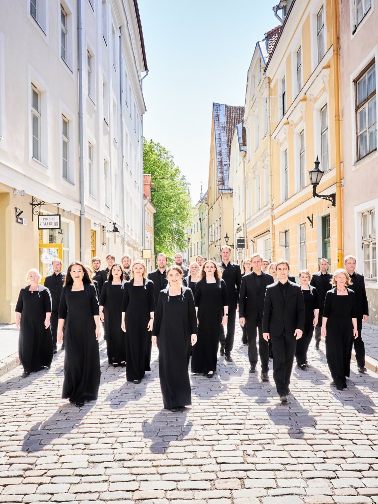 A choir stands in a European street
