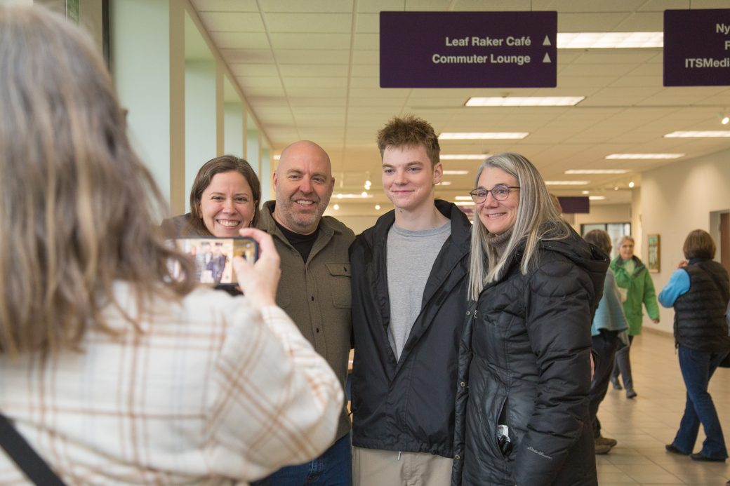 Person taking a photo of a 4-person family