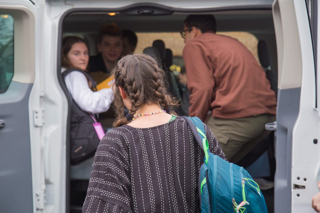 Student getting into a van to leave for SST