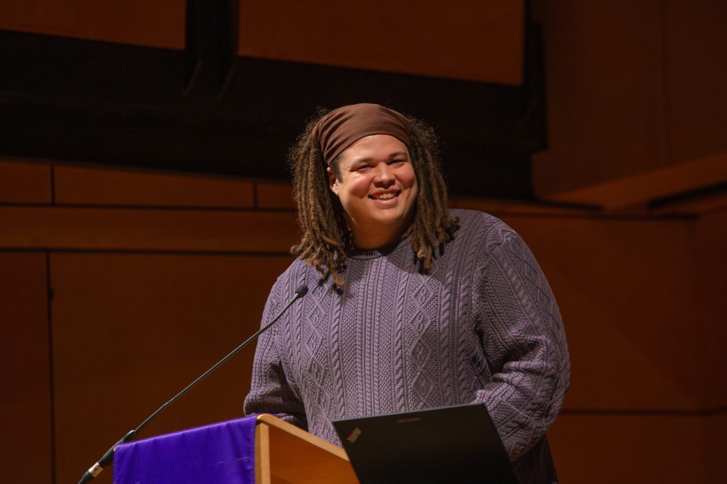 Scott smiling at a lectern