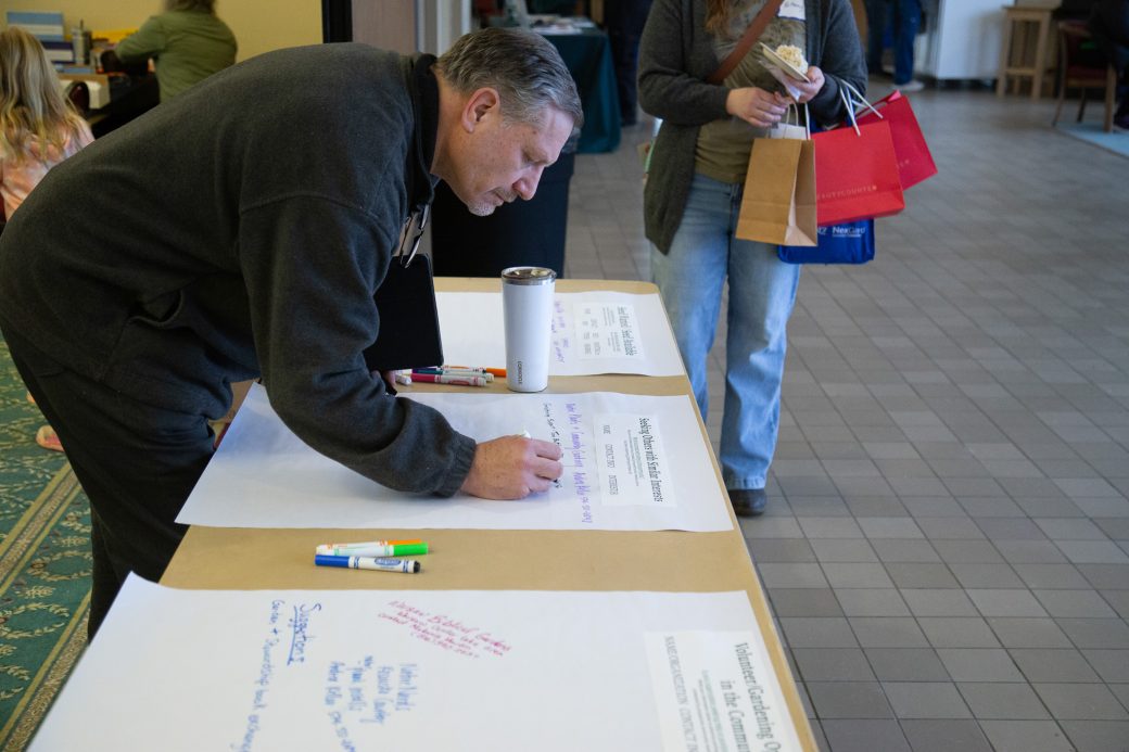 person writing on large sheet of paper