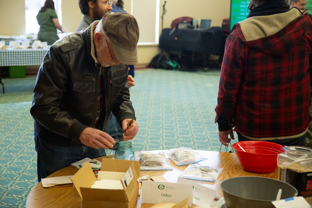 man pouring seeds