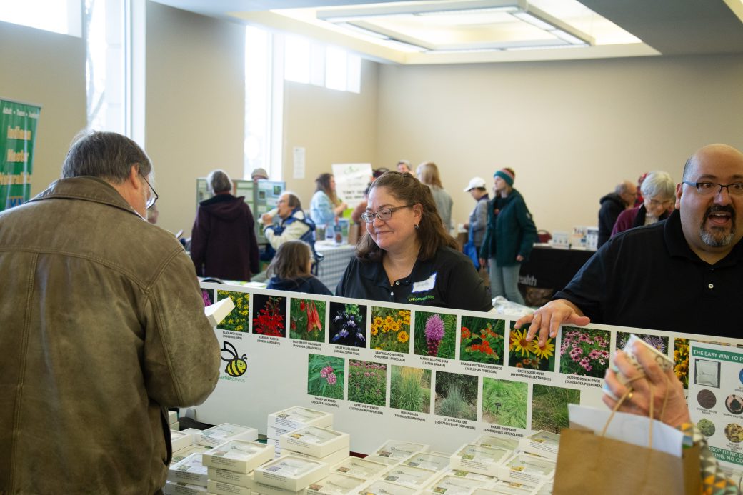 people showing photos of flowers and their seeds