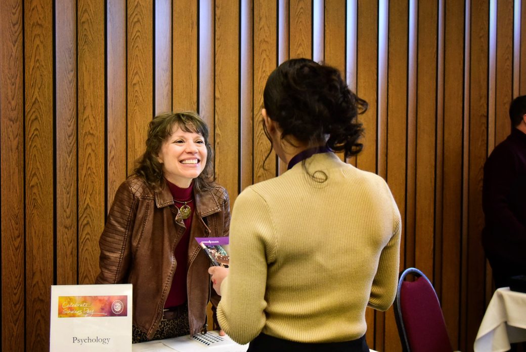 People talking and smiling at Celebrate Scholars Day