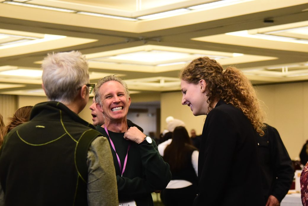 People talking and smiling at Celebrate Scholars Day