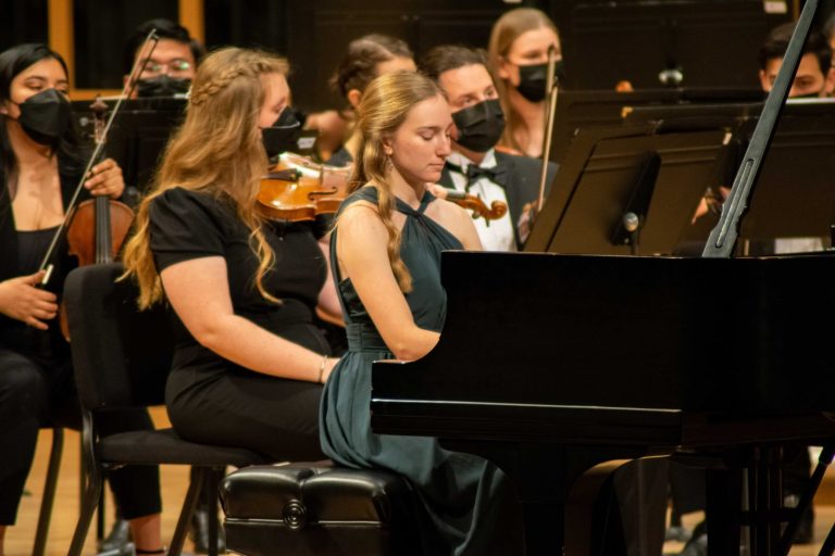 Students play a piano duet