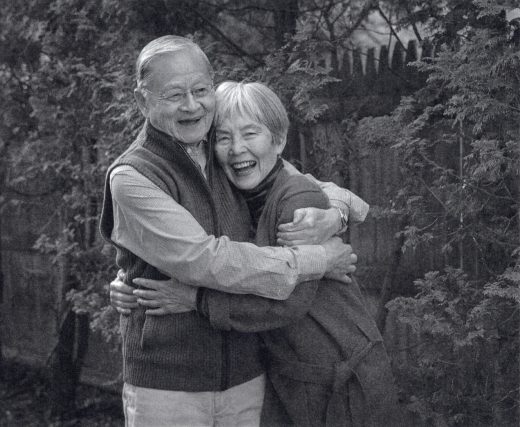 two people hugging each other smiling