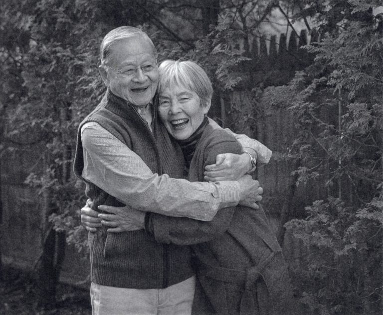 two people hugging each other smiling
