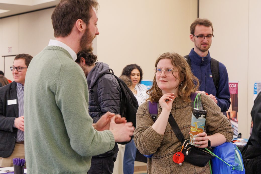 Student and community member in conversation.