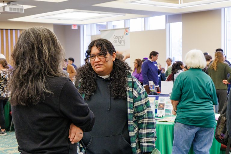 Student and community member in conversation.