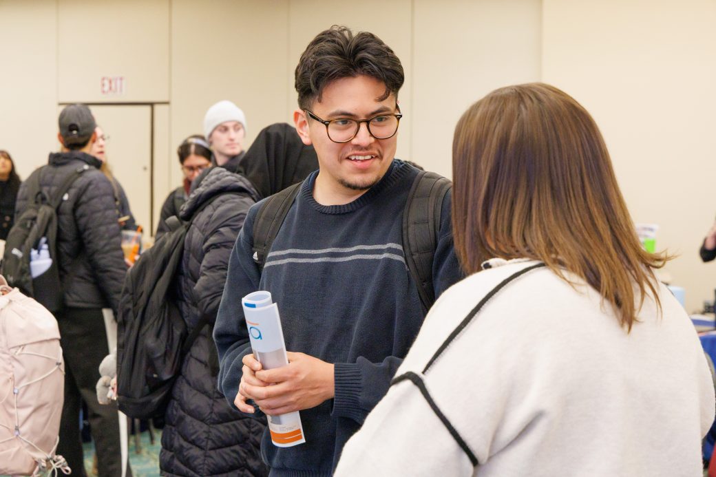 Student and community member in conversation.