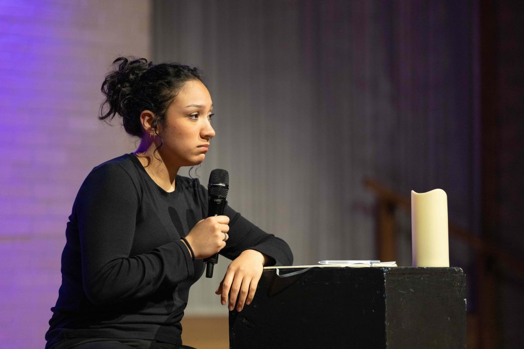 woman seated speaking into mic
