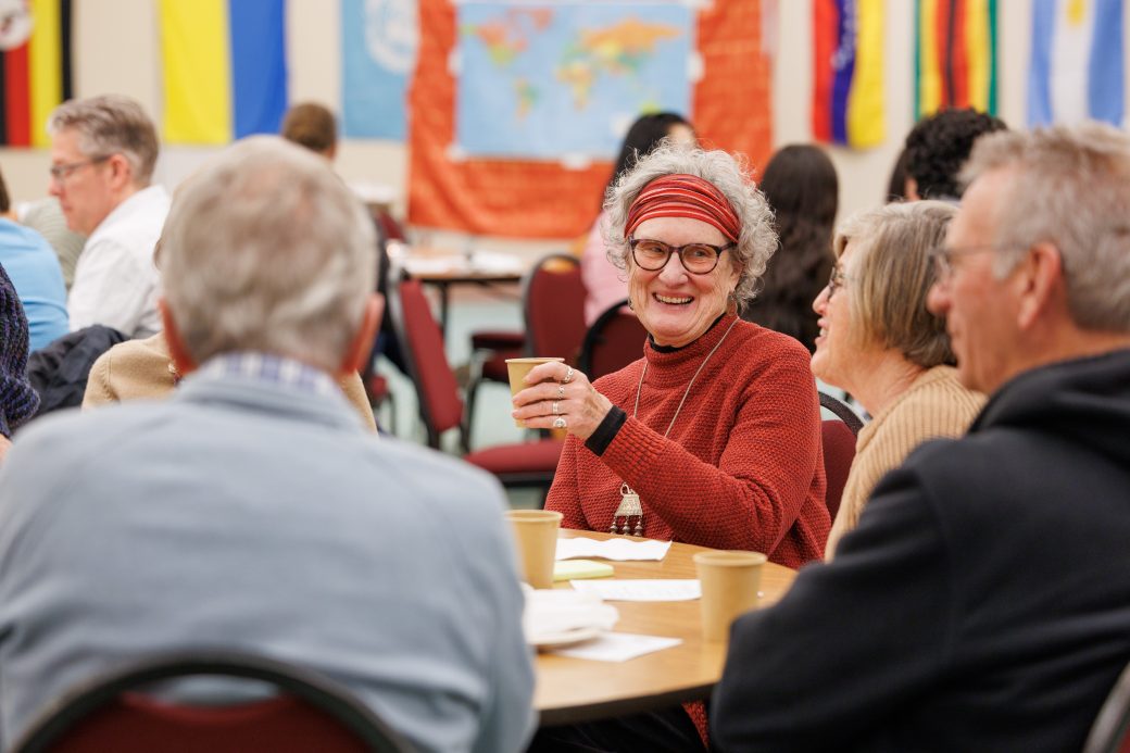 Woman smiling in conversation.
