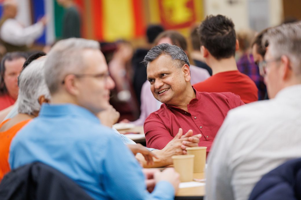 Man smiling in conversation.