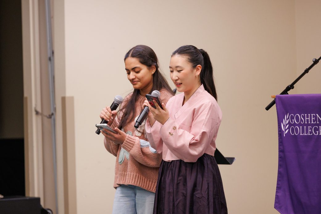 Two women speaking with microphones.