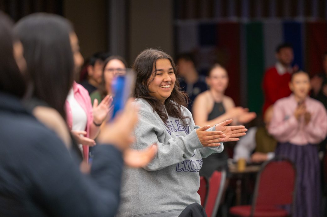 Woman clapping in audience.