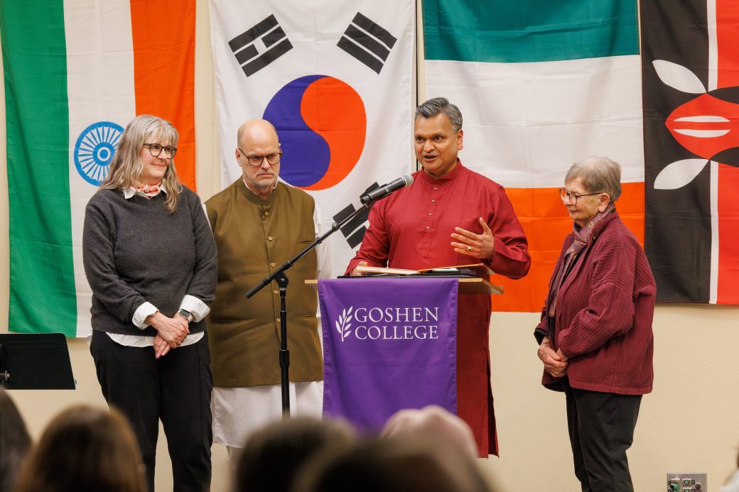 Man speaking and giving award