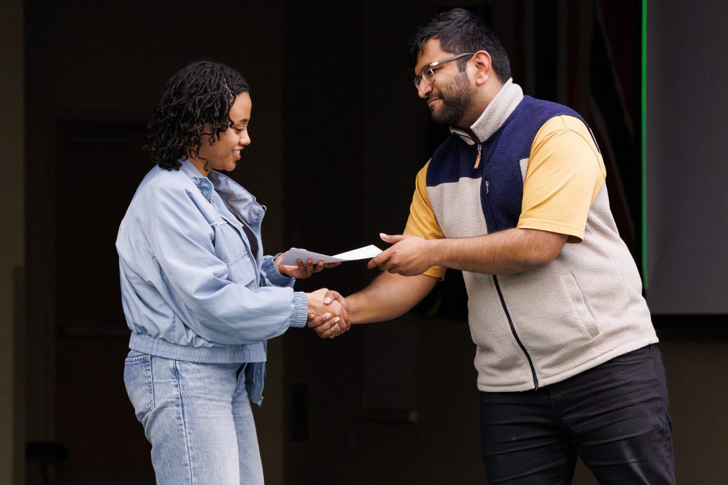 Man giving award to a woman.