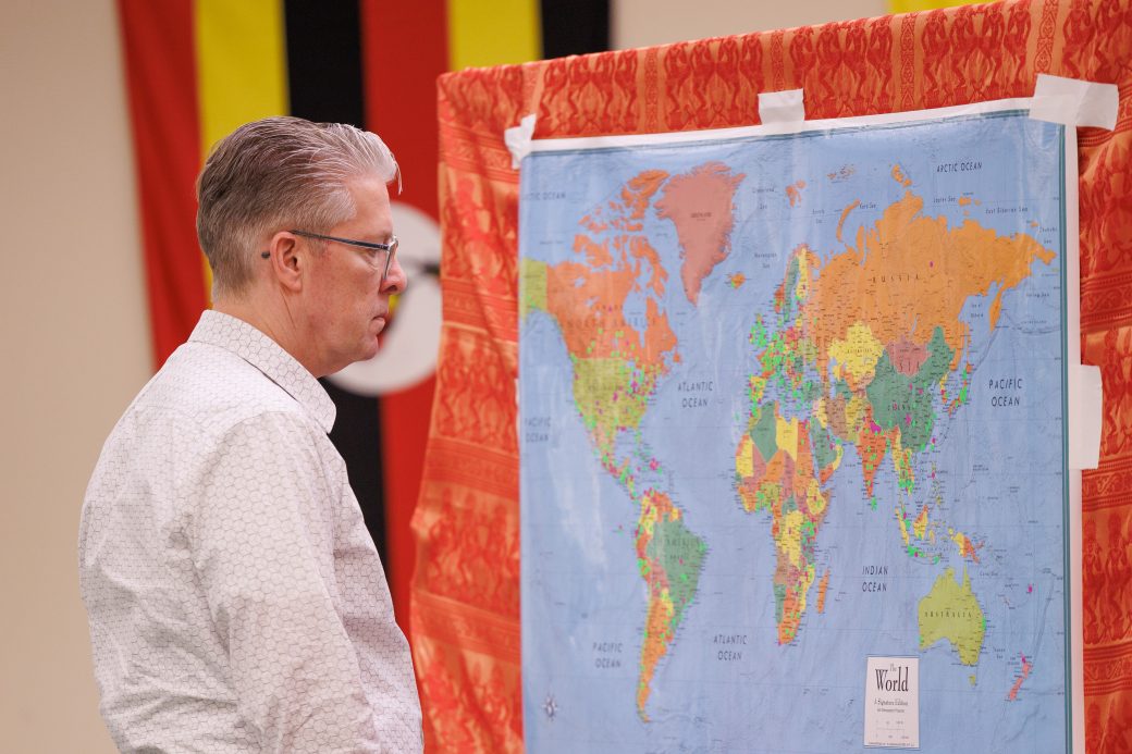 Man looking at a world map.