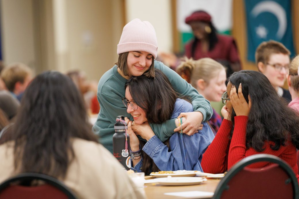 Two friends hugging.