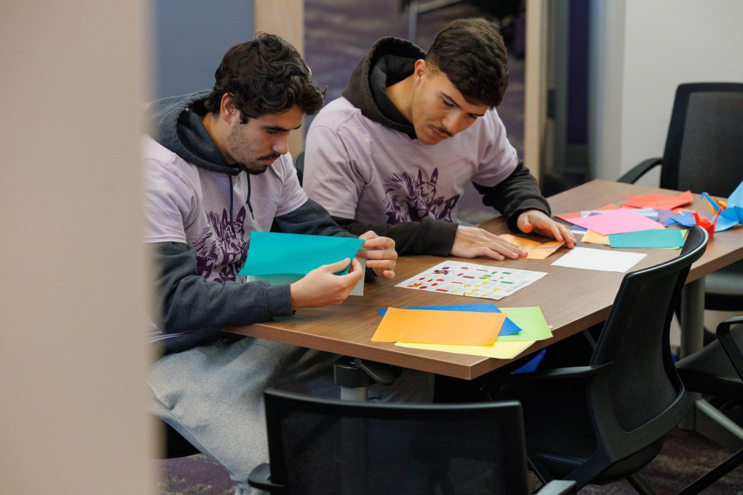 Students folding origami