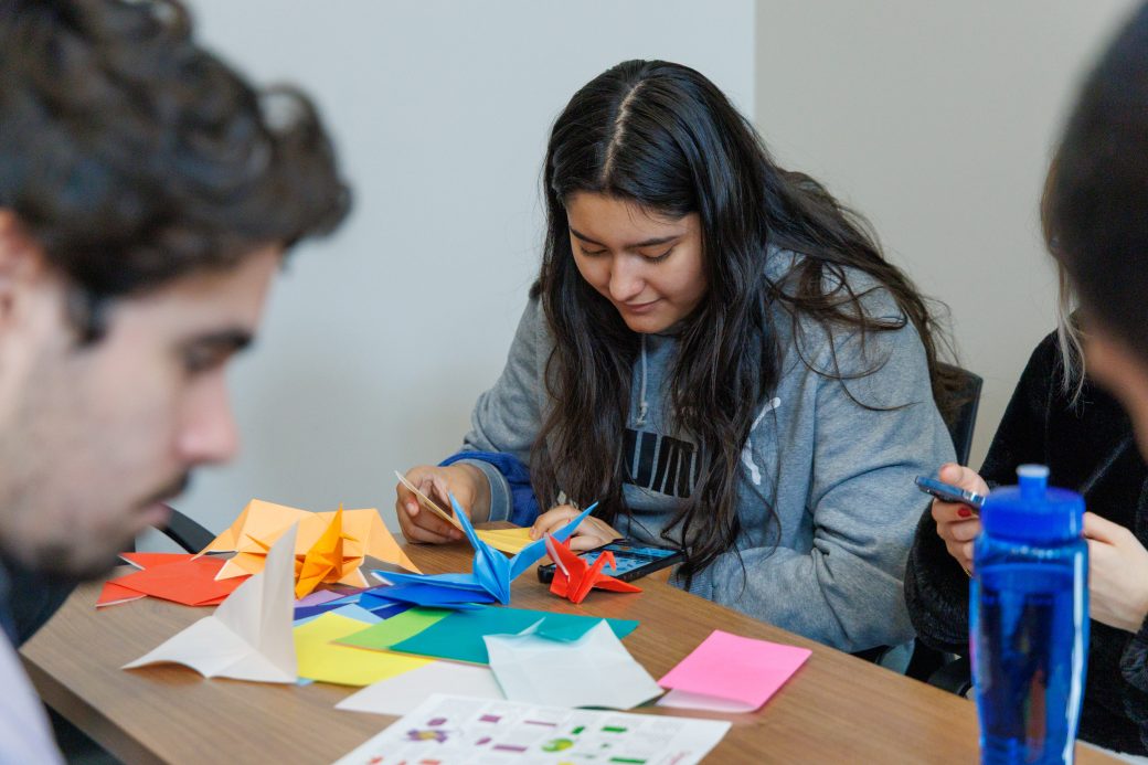 Students folding origami