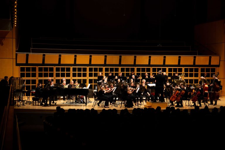 wide shot of orchestra playing on stage