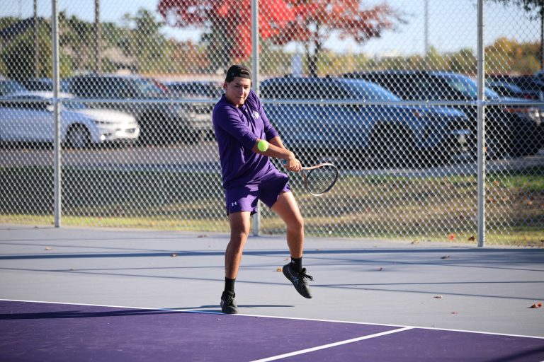 goshen student playing tennis on purple courts
