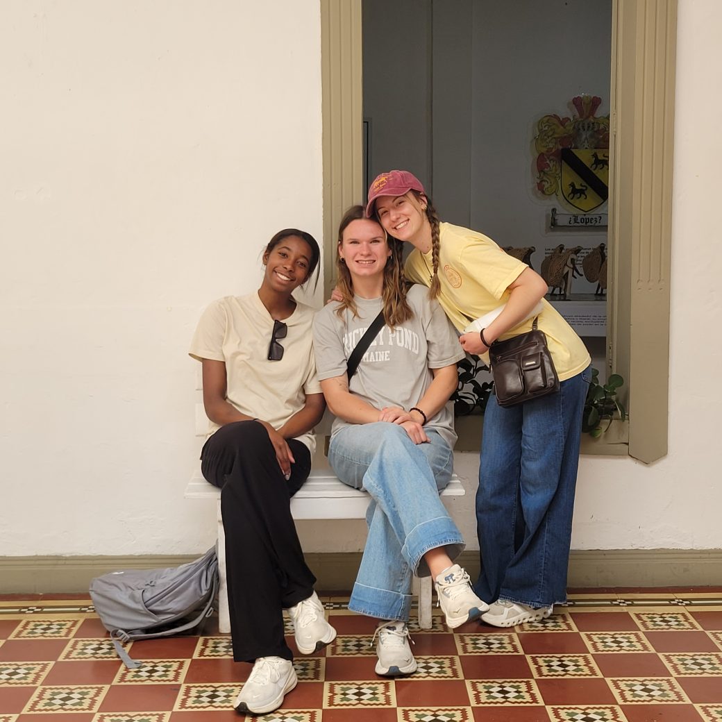 Three people posing for a group photo.