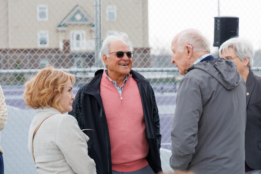 Group smiling talking to Stan